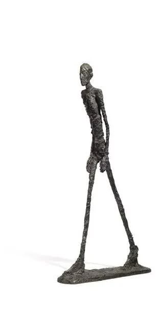 Bronze sculpture of a tall, emaciated figure mid-stride, by Alberto Giacometti.
